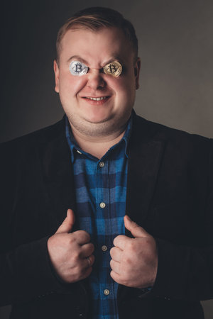 crazy happy bitcoin male lover with golden coin by eyes