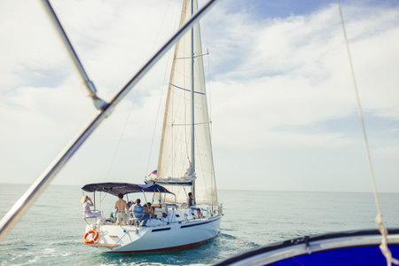 Sailing ship yacht with white sail in the open sea heading to neapolis coast