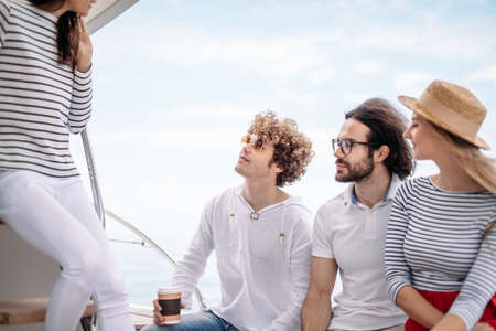 Cheerful people having fun in boat party enjoying summer holidays - Friendship and happiness concept.の写真素材