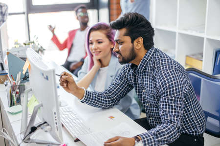 Multiethnic young creative designers people at work in a international office. Luxury space, full of daylight and sun.の写真素材