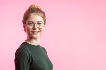 Horizontal portrait of happy female has cheerful expression, dressed in white casual t shirt, expresses positiveness, being glad to spend free time with boyfriend. Smiling woman with stylish hairdoの写真素材