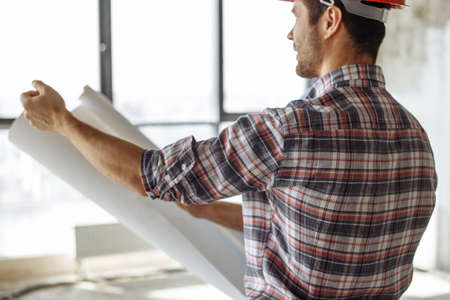 back view photo. pensive constructor is thinking about new project in the neighbourhoodの写真素材