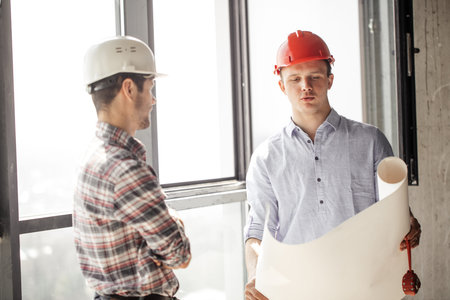 student is showing his blueprint to a teacher during industrial practice. close up photo. studing...