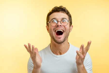 emotional man with positive expression. male is giddy with delight. mans dream has come true