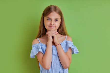 portrait of charming beautiful cute sweet lovely tender girl isolated over pink background, education holiday elementary pre teens event party celebrate concept, she is dreamingの写真素材