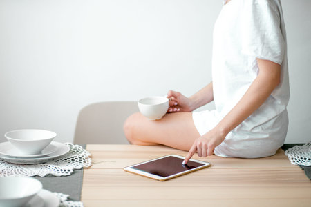 close up cropped photo. focus on the tablet.digital gadget is used by young female