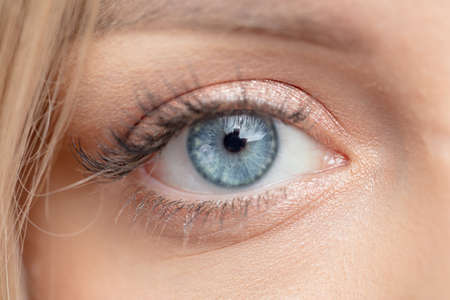 macro image of beautiful blue eye. optic, vision, sight, beauty concept.eye like glass, ice. crystal eyeの写真素材