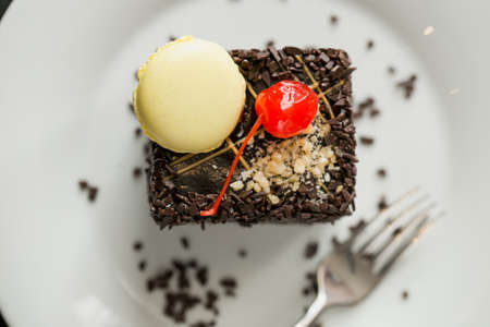 top view image of wonderful baked cake with chocolate and nut sprinkles and cherry and butter cream.goodie.の写真素材