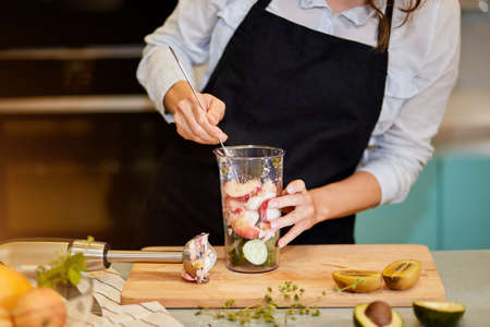 chefs hands mixing fruit with sugar for detox juice. wellness drink concept. close up cropped photo.の写真素材