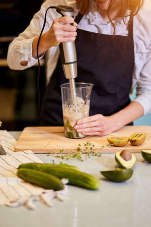 dieting concept. girl making healthy smoothie. close up cropped photo. detox smoothie. culinary dishの写真素材