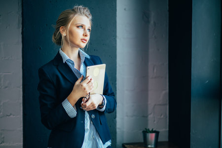 skillful woman with beautiful blue eyes at workplace. working day in the company. thoughts about...