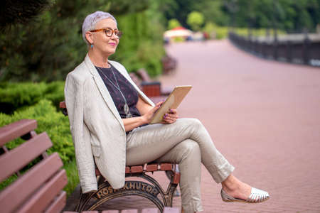 attractive businesswoman is thinking about her company on holiday. side view photoの写真素材