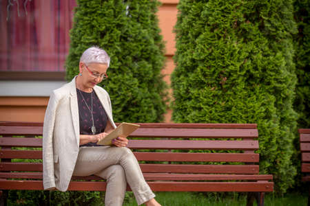 a hardworking woman is making presentation on the tablet. copy spaceの写真素材