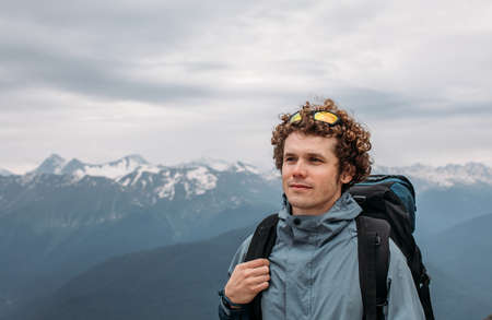 attractive male is going to explore the mountains. close up photo. copy spaceの写真素材