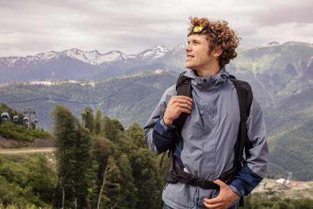 gorgeous young man with rucksackis walking on the mountaines. adventure and leisure time concept....