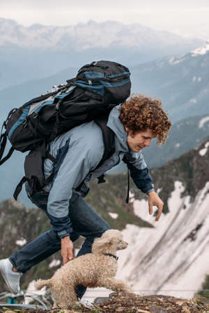 two best frieds atways spend time together. pet is always there. side view photo. unforgettable stroll with a dog on the hillの写真素材
