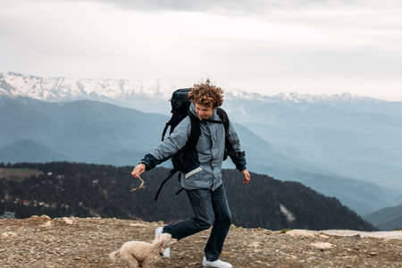 cheerful tourist is running with dog. side view photo.morning jogging with a dogの写真素材