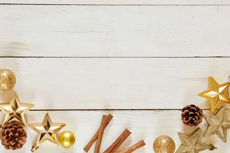 Christmas decoration. wooden background with copy space. Golden balls, stars and brownish aestheticsの写真素材