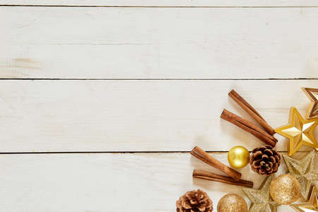 Christmas decoration. wooden background with copy space. Golden balls, stars and brownish aestheticsの写真素材