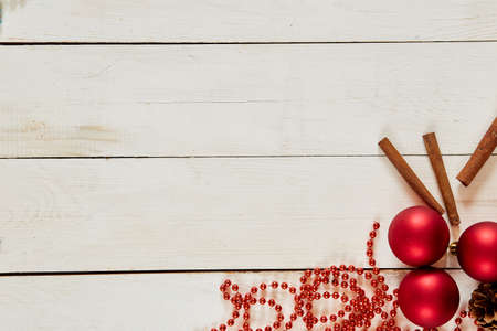 Closeup of red Christmas balls and fir branch on white wood backgroundの写真素材