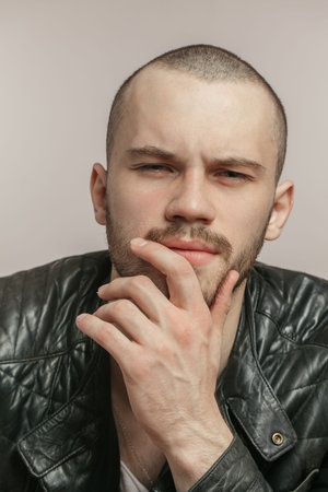 macho with sceptic look. close up portrait. young bearded man with incredulous look. distrustful...