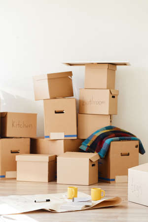 stack of boxes opened after moving in roomの写真素材