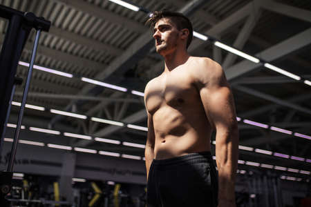 Fitness handsome male instructor pulling kettlebells weights in the functional fitness gym. Sport, fitness, bodybuilding, lifestyle and people conceptの写真素材