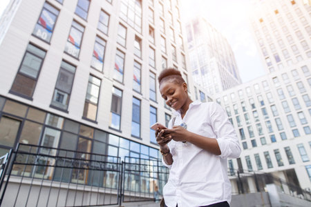 travel, business trip, people and technology concept - happy young african american woman in white...