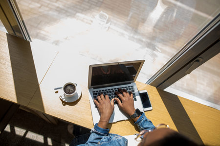 Workplace of businesswoman with a laptop, smart phone and cup of coffee, top view. Business,...