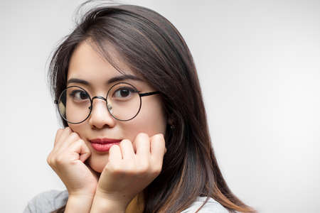 Portrait of beautiful Asian lady with clean skin and expressive eyes looking aside isolated over white background with copyspace, close up. Oriental Beauty, Skin Care, Cosmetology Conceptの写真素材