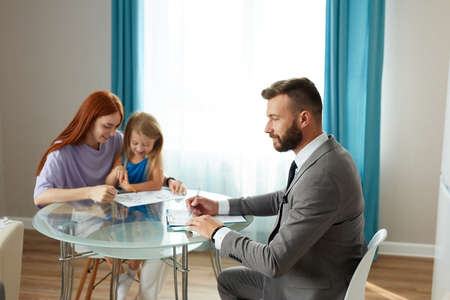 single lonely mother with kid girl and psychologist, husband left his family, went to another mistress. sad depressed redhead woman get support and help by professional therapistの写真素材