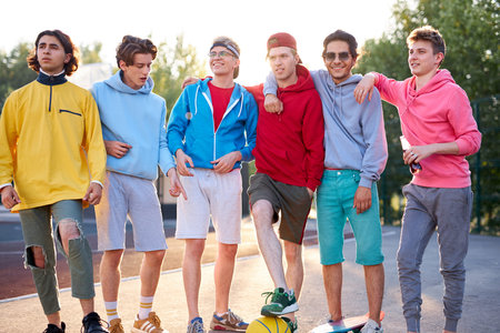 diverse young city boys are ready to play basketball together, sport club members have fun outdoors,...