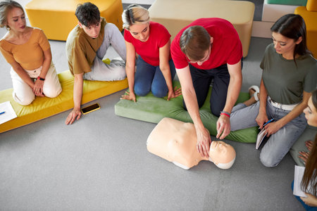 CPR class with young caucasian instructors speaking and demonstrating help first aid, cpr mannequin...
