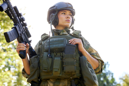 young caucasian military woman holds a gun in her hand in nature, she is going to hunt, hunting in...