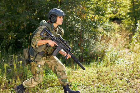 confident caucasian female hunter saw animal, going to shoot, in the forest. woman sneak up