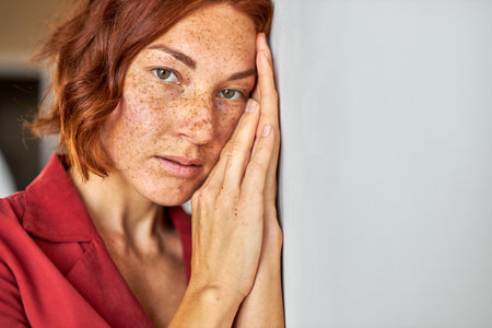 mysterious woman with red hair looking at camera, young lady with natural beauty, having piercing gazeの写真素材