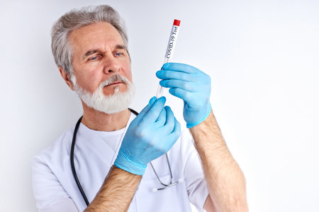 doctor holding a test tube of liquid solution in a laboratory, preparing results. epidemic pandemic coronavirus 2019-ncov sars covid-19 flu virus conceptの写真素材