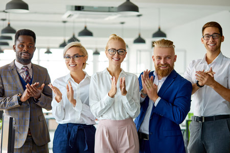 portrait of successful multi-ethnic team looking at camera in the office, posing, young people have...