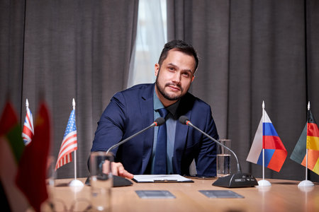 businessman sit speaking into the microphone at meeting, offering new ideas and solutions for...