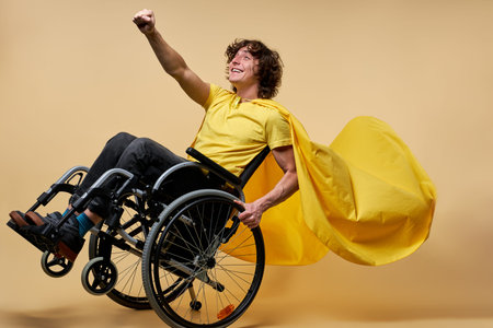 handicapped man in yellow cloak pretend to be superhero with arm raised