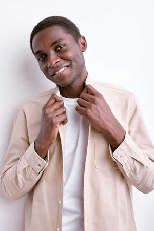 Smiling African Man Posing At Camera Holding Collar, Smartening Upの写真素材