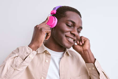 Young Afro American Guy Enjoy Listening To Music In Headphonesの写真素材