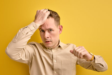 young confused man nervous about something isolatedの写真素材