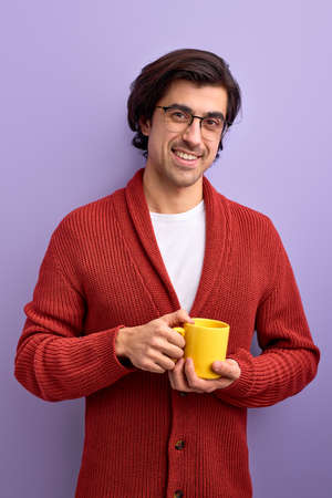 Young handsome smiling man drinking tea in morning, enjoy lifeの写真素材