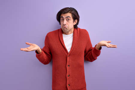 young caucasian guy in casual wear shrugging, male doesnt know, misunderstandingの写真素材