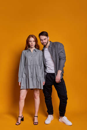 portrait of fashionable man and woman in party wear posing together isolatedの写真素材