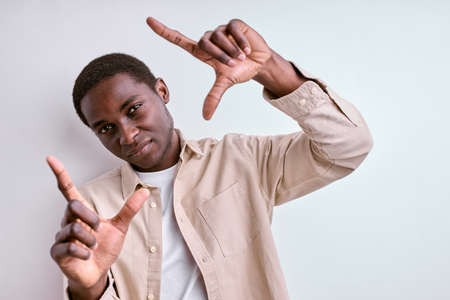 photography concept. african man making square shape from handsの写真素材