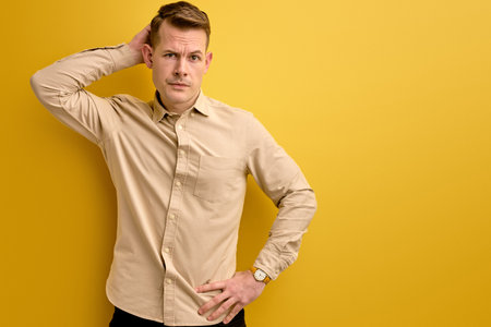 let s me think. man doubts his decision, isolated over yellow backgroundの写真素材