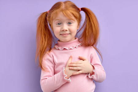 Nice Redhead Child Girl Holding Hands On Chest, Feeling Gratitude or Dreaming