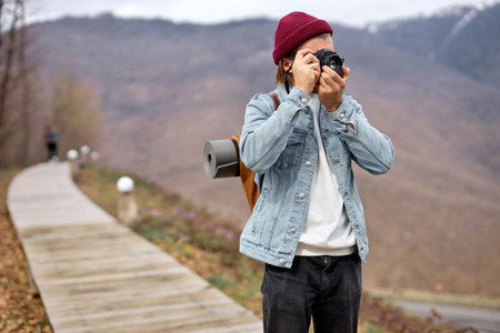 Young Handsome Photographer man Taking Photo on camer while walking, traveling. caucasian Traveler...